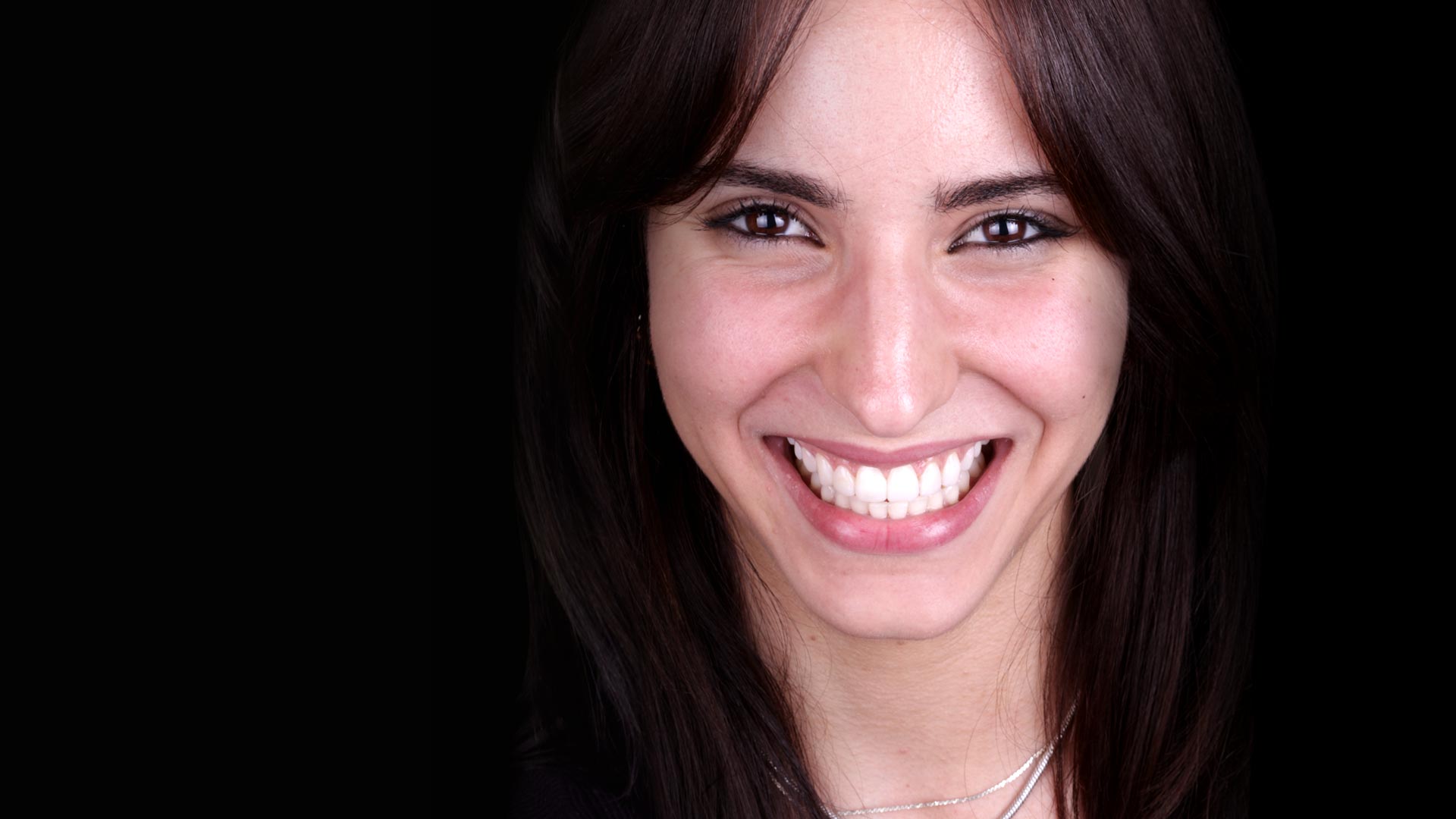 A young woman showing off her new smile with Digital Smile Design